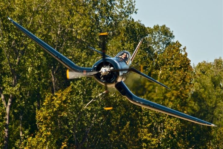 Airborne photo of a World War II single-engine fighter plane called an F4U Corsair
